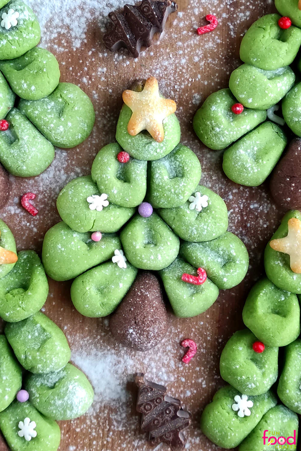 Green pull apart Christmas tree cookies made of dough balls with chocolate trunks, star tops and sprinkles on parchment