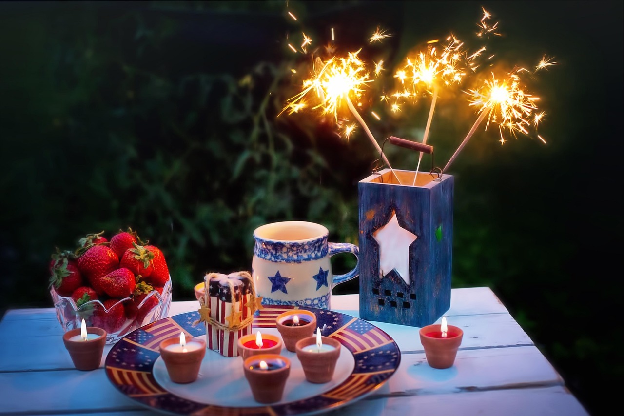 A table set for the 4th of July party with sparklers and patriotic treats