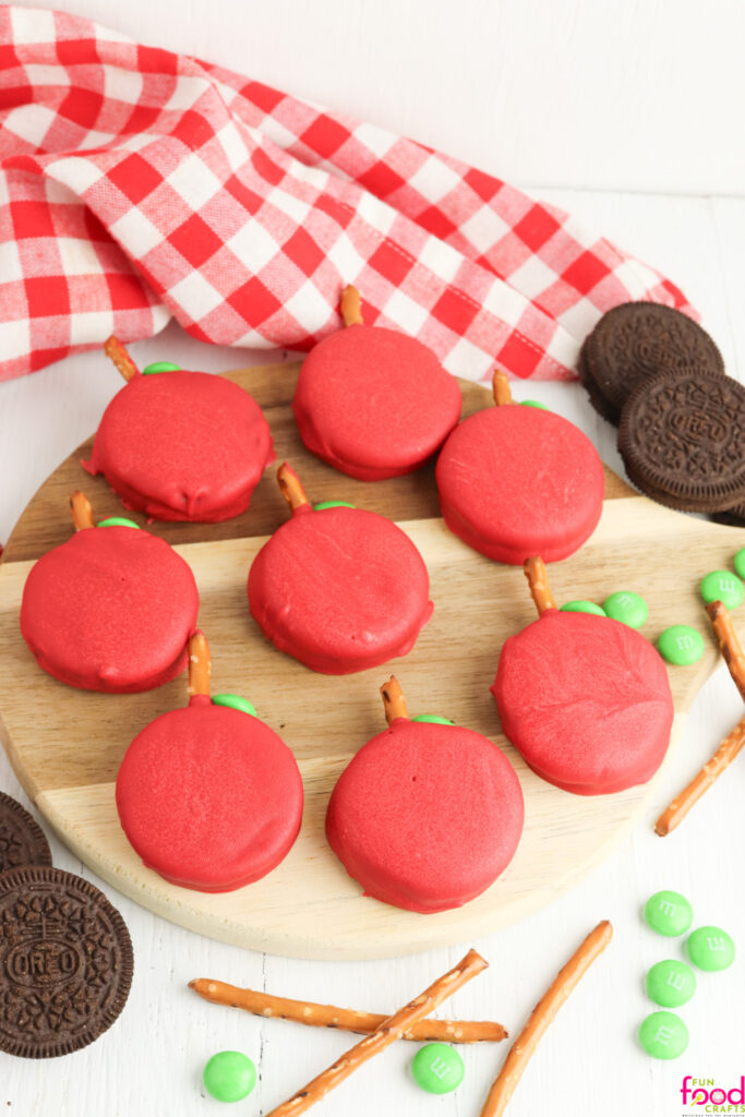 Cookies on a cutting board with a red and white checkered napkin above the board