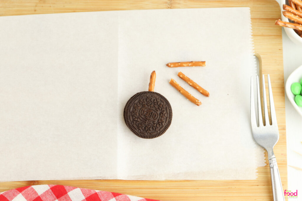 insert a pretzel into the oreo for the apple stem