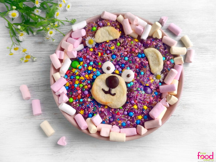 finished teddy bear cookie surrounded by marshmallows