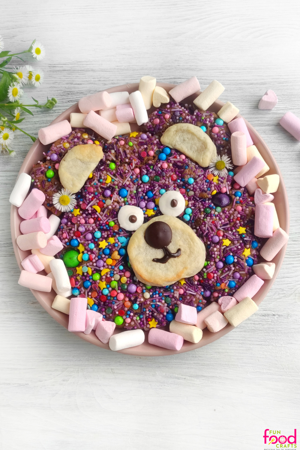 Close up of giant teddy bear cookie decorated with sprinkles