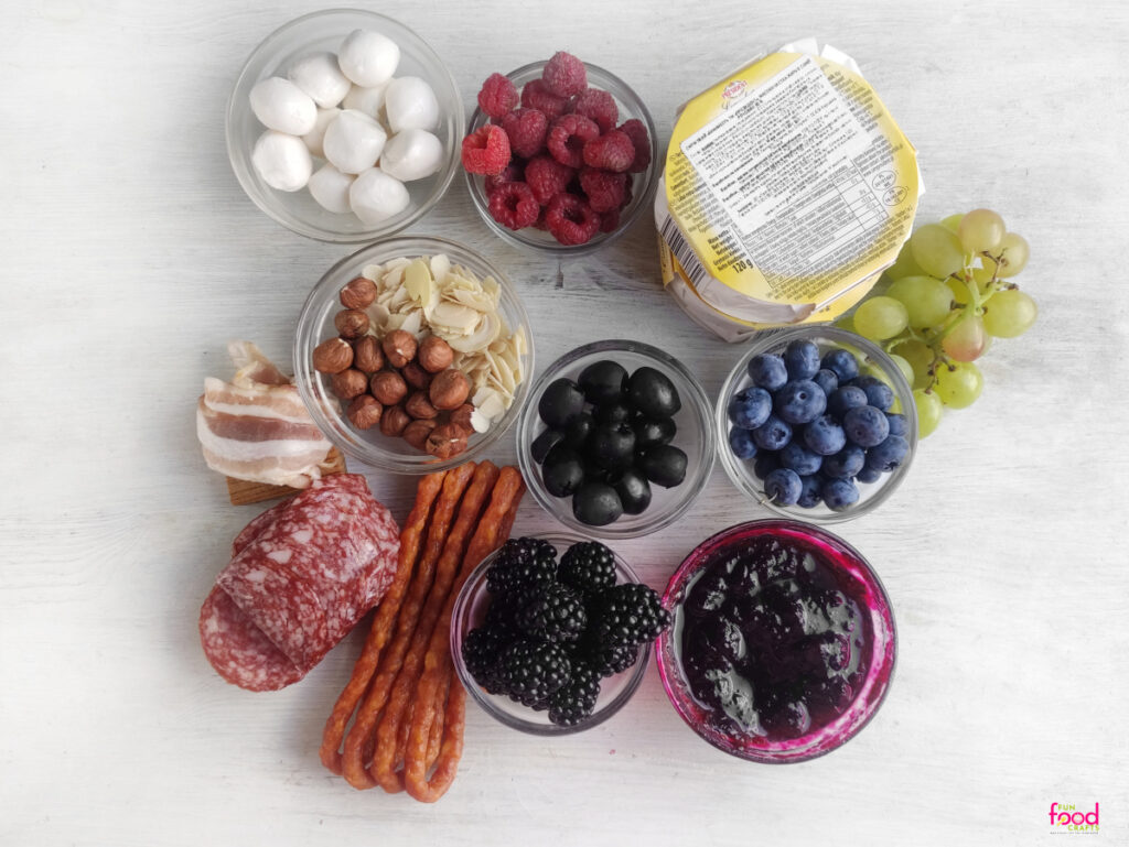 Ingredients for this Nightmare Before Christmas Halloween Charcuterie Board laid out in bowls on a white background