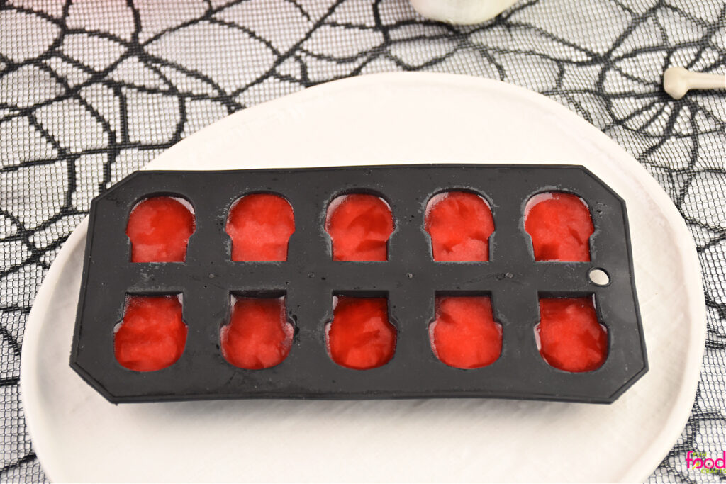 Frozen cheery flavored ice skulls in the mold