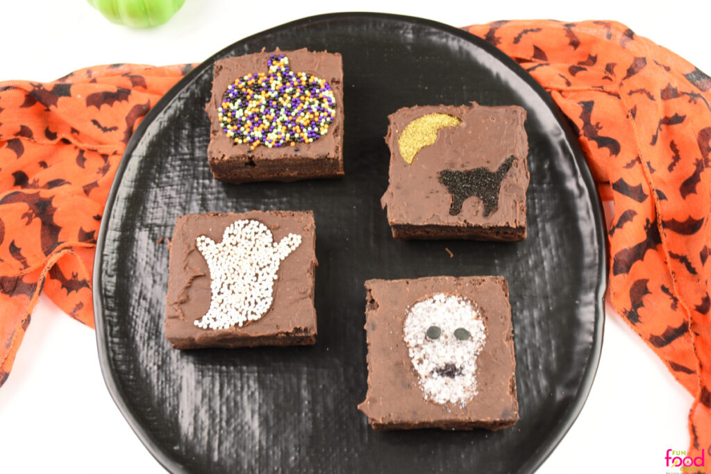 Finished Halloween Sprinkle Brownies decorated with ghosts, pumpkins, cats, and skulls made from colorful sprinkles.