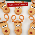 Close up of finished Nutter Butter Reindeer Christmas Cookies made using Nutter Butter cookies, pretzel antlers, and candy eyes and nose