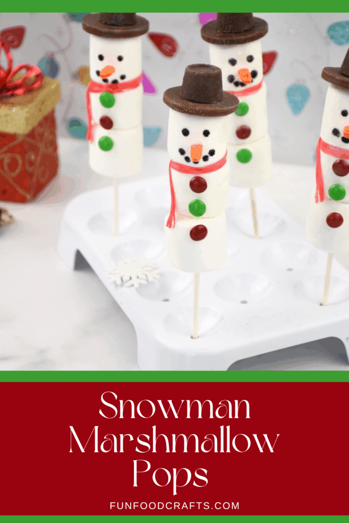 Close up of four finished snowman marshmallow pops with hats and scarves sitting in a cake pop stand