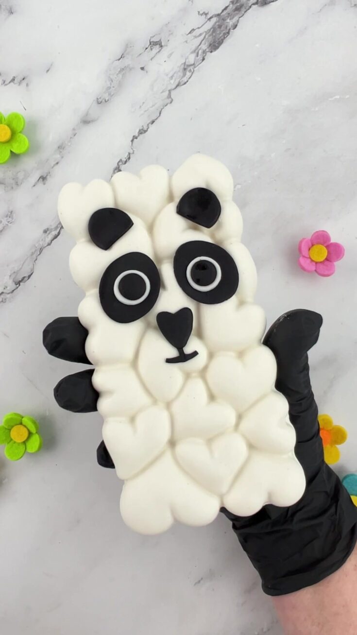 Homemade panda chocolate bar made with white candy melts and black-and-white fondant details